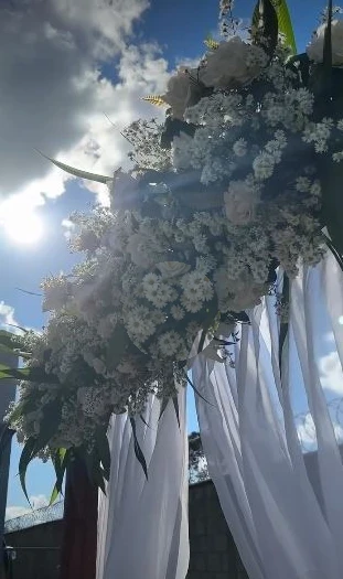 Arco de flores brancas e cortinas da cerimônia